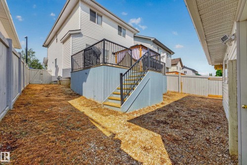 Raised deck with black metal railing and built-in steps - 1223 Gillespie Crescent Nw, Edmonton, AB 