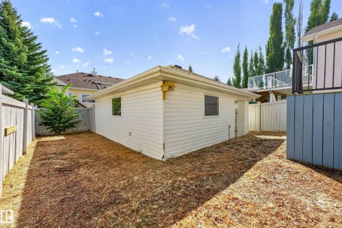 Detached garage structure with white horizontal siding and a low-pitch roof - 1223 Gillespie Crescent Nw, Edmonton, AB 