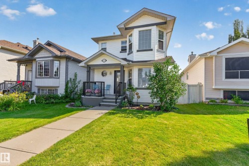 Two-story exterior with white siding and dark trim, featuring a prominent bay window on the second level - 1223 Gillespie Crescent Nw, Edmonton, AB 