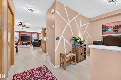 Light wood-finish flooring extending through the entry and into living areas - 1223 Gillespie Crescent Nw, Edmonton, AB 