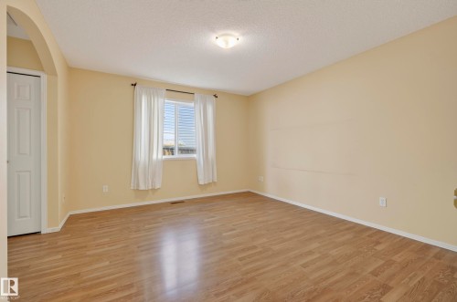 Wood-finish flooring, recessed window, archway entry, and a ceiling-mounted light fixture - 15213 49A Street Nw, Edmonton, AB 