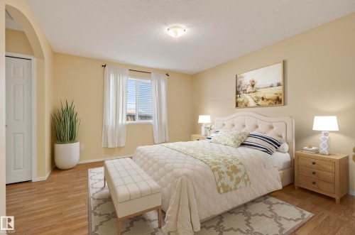 Wood-finish flooring, recessed lighting, arched doorway, window with blinds, and neutral wall paint - 15213 49A Street Nw, Edmonton, AB 