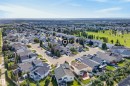 Residential neighborhood setting with tree-lined streets and a nearby expansive green space - 15213 49A Street Nw, Edmonton, AB 