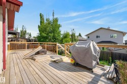 Expansive wood deck with a perimeter wood railing and privacy fencing - 
