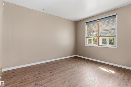 Wood-finish flooring with neutral wall tones and white trim - 5501 48 Avenue, Wetaskiwin, AB 