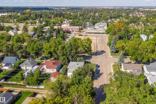 Residential neighborhood with mature trees and a commercial district in the background - 5501 48 Avenue, Wetaskiwin, AB 