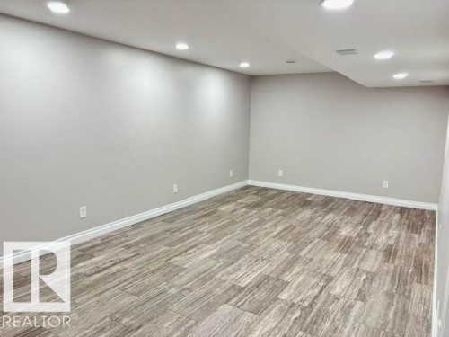 Recessed lighting, light gray wall finishes, wood-finish flooring, and white trim - 5133 45A Avenue, Vegreville, AB 