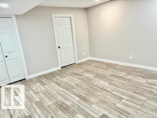 Wood-finish plank flooring, white trim, recessed lighting, and a neutral wall color - 5133 45A Avenue, Vegreville, AB 
