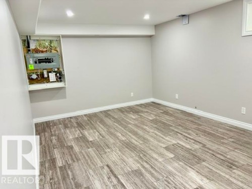 Recessed lighting with a drop ceiling, light-toned walls, and wood-finish flooring - 5133 45A Avenue, Vegreville, AB 