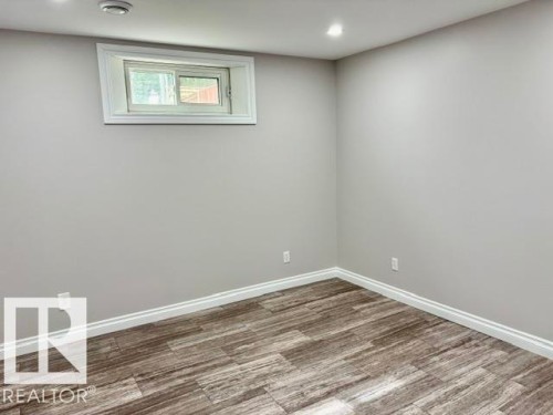 Wood-finish flooring, recessed lighting, and a white-trimmed window - 5133 45A Avenue, Vegreville, AB 