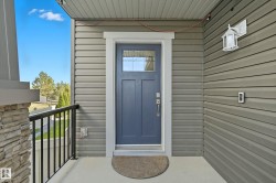 Inviting entry featuring a paneled door with integrated glass, complemented by durable horizontal siding - 