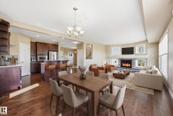 Open-concept living space with wood-finish flooring - 