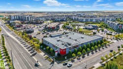 Commercial building with expansive surface parking, positioned at a signalized intersection - 