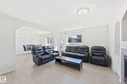 Spacious living area featuring light wood-finish flooring and a contemporary flush-mount ceiling light - 