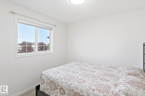 White walls with a single window unit, featuring a flush-mount ceiling light - 3525 22 St Nw, Edmonton, AB 
