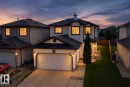 Two-story residence featuring a two-car garage, front walk-up, and a landscaped front yard - 3525 22 St Nw, Edmonton, AB 