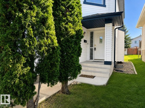 White siding exterior with dark trim accents - 3525 22 St Nw, Edmonton, AB 