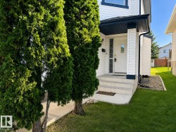 White siding exterior with dark trim accents - 