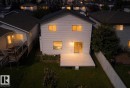 Two-story residence with a rear deck, sliding glass door, and fenced backyard - 3525 22 St Nw, Edmonton, AB 