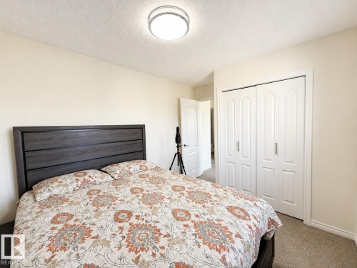 Recessed lighting, light-toned walls, and a built-in bi-fold closet - 3525 22 St Nw, Edmonton, AB 