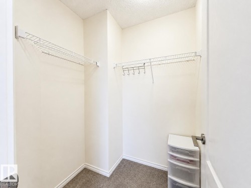 Recessed closet featuring carpet flooring, painted walls, and white wire shelving - 3525 22 St Nw, Edmonton, AB 