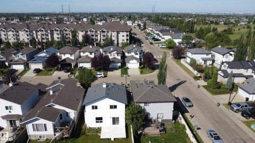 Residential area featuring detached homes with asphalt shingle roofs and private driveways - 3525 22 St Nw, Edmonton, AB 