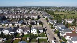 Residential street with single-family homes and apartment complexes - 