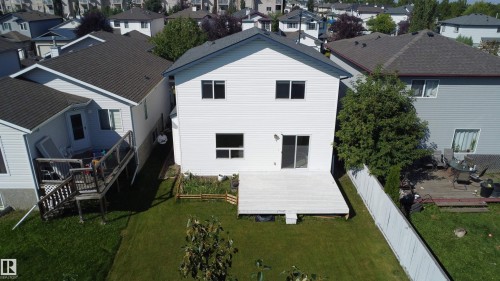 Expansive backyard featuring a manicured lawn, a large deck, and a privacy fence - 3525 22 St Nw, Edmonton, AB 