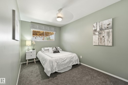 Room featuring neutral wall color, overhead ceiling fan with lighting, and a large window with a valance - 10552 45 Street Nw, Edmonton, AB 