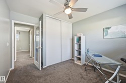 Carpeted flooring throughout, ceiling fan with integrated lighting, and white bi-fold closet doors - 