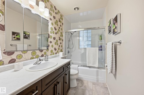 White vanity countertop with an integrated oval sink and chrome faucet - 10552 45 Street Nw, Edmonton, AB 
