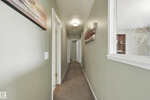 Hallway with light-colored walls and carpet flooring - 10552 45 Street Nw, Edmonton, AB 