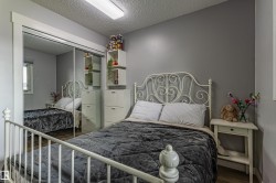 Wood-finish flooring, mirrored sliding closet doors, and neutral wall tones - 
