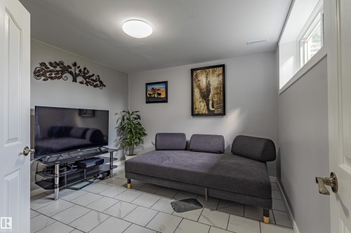 Recessed window, ceiling-mounted light fixture, tile flooring, and light-toned walls - 7408 180 Street Nw, Edmonton, AB 