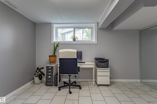 Recessed window with white trim, light gray walls, tile flooring, and mirrored closet doors - 7408 180 Street Nw, Edmonton, AB 