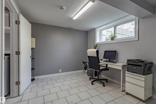 Recessed window, modern tiled flooring, neutral wall tones, built-in shelving, and overhead fluorescent lighting - 7408 180 Street Nw, Edmonton, AB 