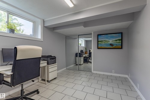 Recessed lighting, tile flooring, window with natural light, mirrored closet doors, and painted structural beams - 7408 180 Street Nw, Edmonton, AB 