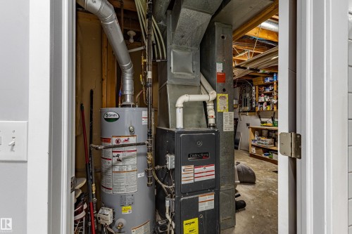 Utility space featuring a water heater and furnace - 7408 180 Street Nw, Edmonton, AB 
