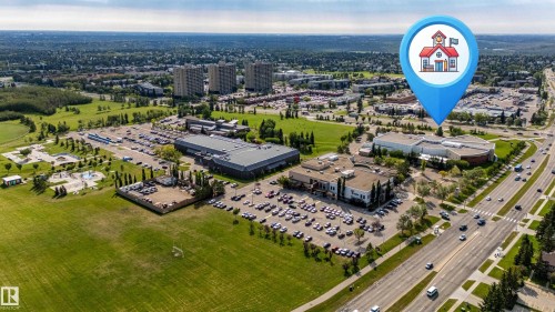 Expansive green spaces and mature trees surround the property - 7408 180 Street Nw, Edmonton, AB 