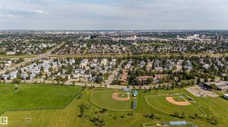 Expansive green spaces featuring multiple sports fields and baseball diamonds - 