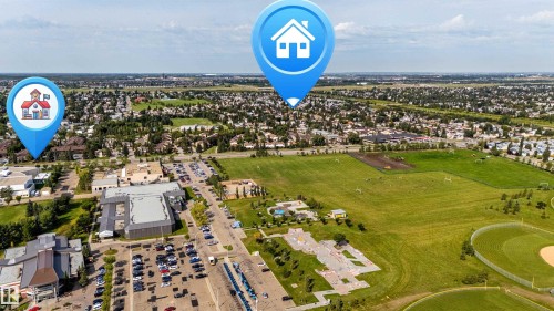 Expansive open green spaces, athletic fields, and a community park with recreational features - 7408 180 Street Nw, Edmonton, AB 