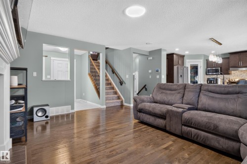 Wood-finish flooring throughout main living area - 1332 72 Street Sw, Edmonton, AB 