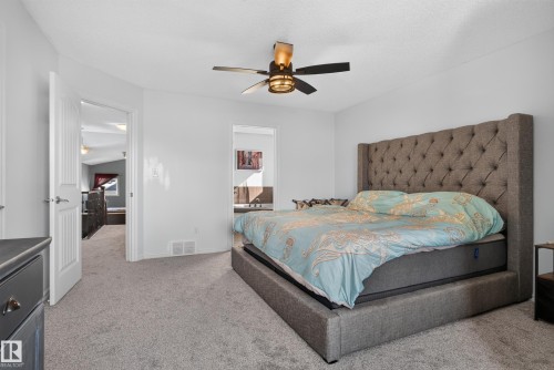 Recessed lighting with a ceiling fan, carpet flooring, and a doorway to an additional room - 1332 72 Street Sw, Edmonton, AB 