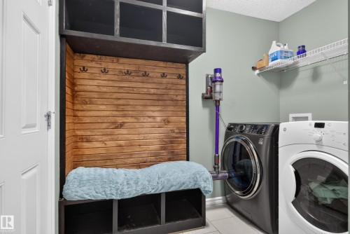 Built-in wood-finish shelving unit with coat hooks, storage cubbies, and overhead compartments - 1332 72 Street Sw, Edmonton, AB 