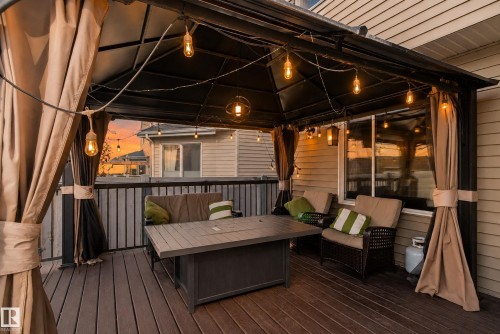 Private outdoor deck with composite decking, a permanent gazebo structure, and integrated string lighting - 1332 72 Street Sw, Edmonton, AB 
