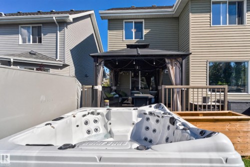 Expansive outdoor space featuring a hot tub, wood decking, and a covered gazebo - 1332 72 Street Sw, Edmonton, AB 