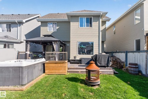 Expansive backyard featuring a manicured lawn, multi-level wood deck, and privacy fencing - 1332 72 Street Sw, Edmonton, AB 