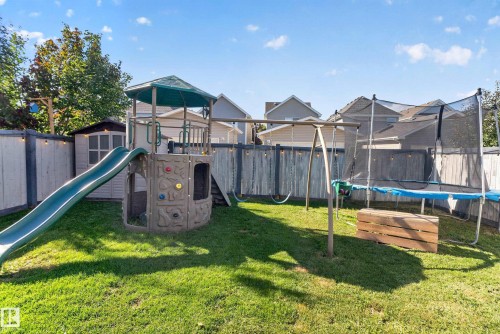Expansive fenced yard featuring a storage shed and mature perimeter trees - 1332 72 Street Sw, Edmonton, AB 