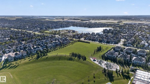 Residential area featuring a large body of water, extensive green spaces, a public park with a playground, and numerous single-family homes - 1332 72 Street Sw, Edmonton, AB 