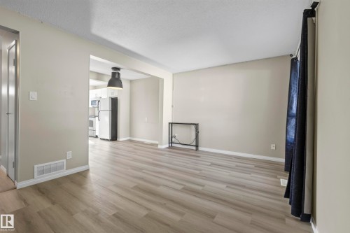 Wood-finish flooring throughout, light neutral wall tones, and recessed ceiling lighting - 141 Dickinsfield Court Nw, Edmonton, AB 